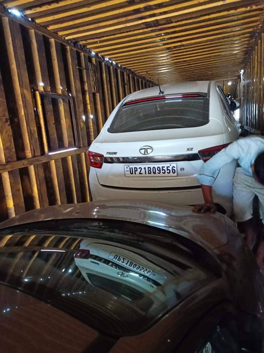 Car being secured inside carrier — ShiftEzy vehicle transport service